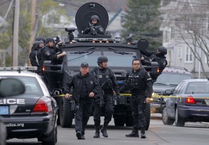 SWAT teams enter a suburban neighborhood to search an apartment for the remaining suspect in the Boston Marathon bombings in Watertown